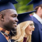 happy students or bachelors in mortar boards